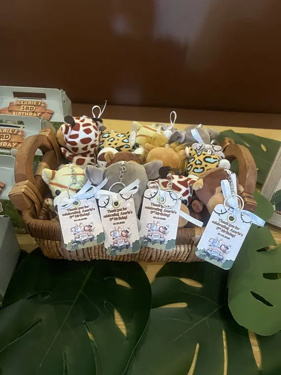 Basket of plush safari favours with thank-you tags