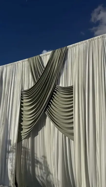 Draped fabric backdrop detail against blue sky