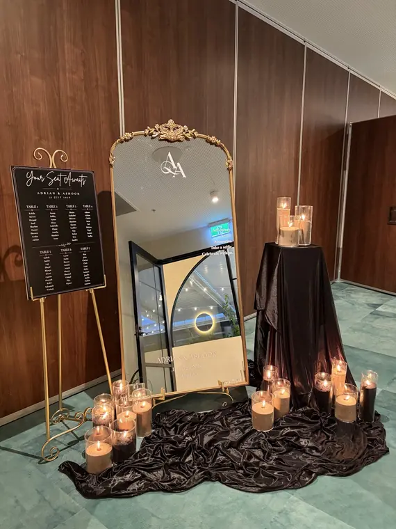 Monogram mirror and seating chart signage styled with candles