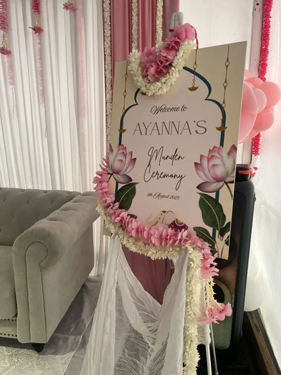 Mundan ceremony welcome sign with floral garland
