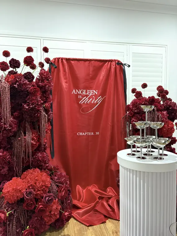 Red floral wall backdrop with champagne tower