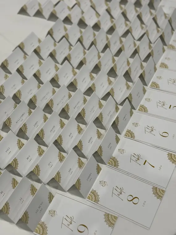 Rows of gold-detailed table number place cards