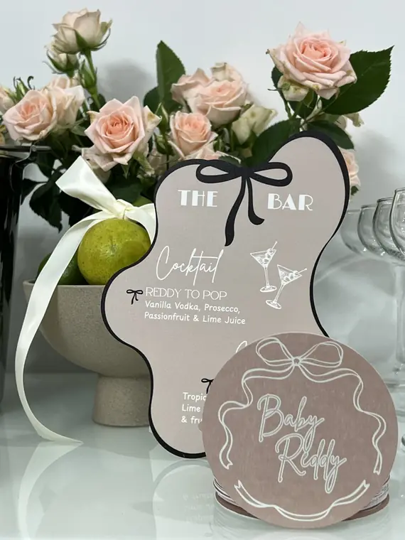 The Bar cocktail menu sign and Baby Reddy welcome plaque